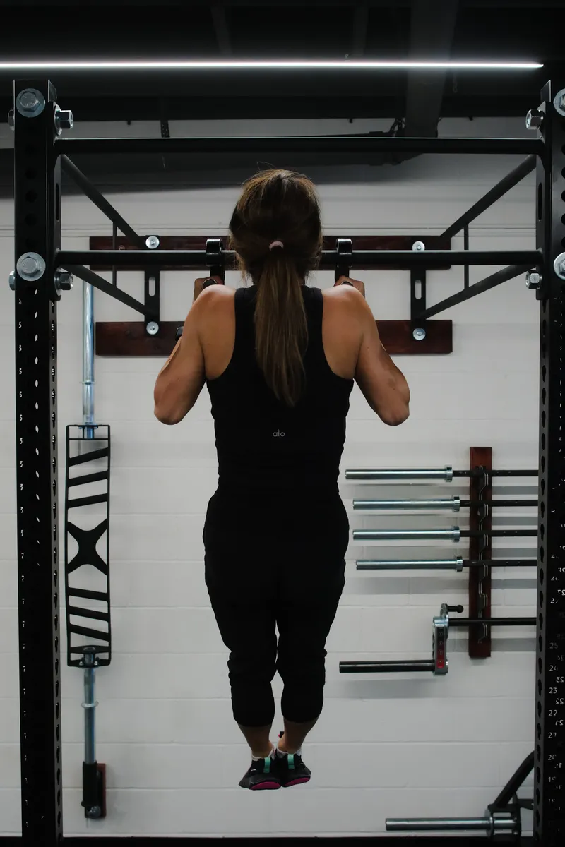 Strict pull-ups on the wall-mounted training rig